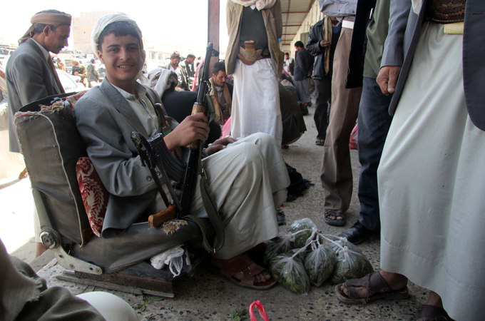 Yemen. Qat trader with Kalashnikov. Armed conflict is a major stumbling block for conservation in Yemen. Kevin Rushby - saving the leopard - witness