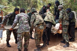 Thai soldiers evacuate an injured soldier after he was shot in an exchange of gunfire with Cambodian troops in Surin province