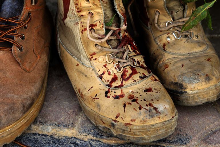 Blood stained boots of a killed rebel fighter are seen outside the emergency ward of Misrata hospital