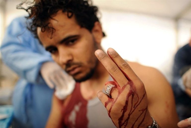 A wounded Libyan rebel flashes the victory sign - Misurata