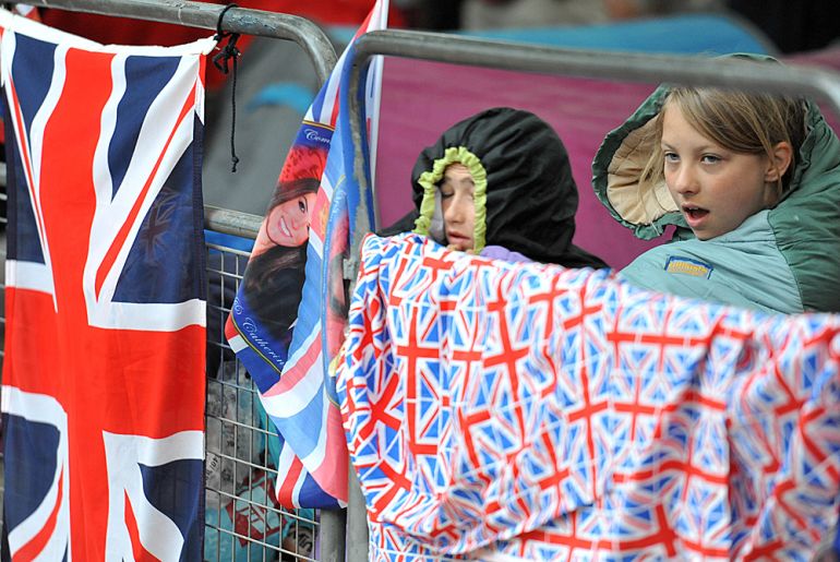 Young royal well-wishers relax near their tents after camping outside the Mall in Central London on the day of the wedding of Prince William and Kate Middleton