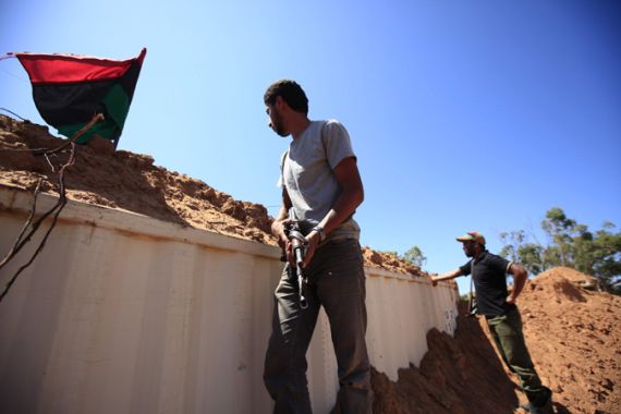 Libyan rebel fighters keep watch after seeing signs of movement from forces loyal to Muammar Gaddafi