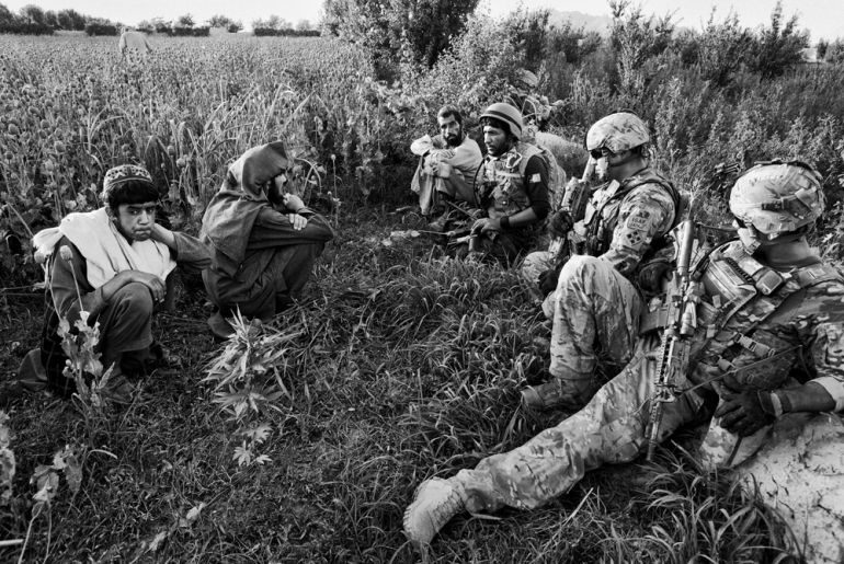 US and Afghan soldiers talk to local farmers