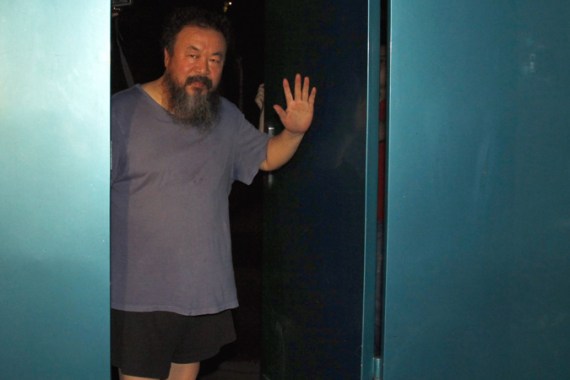 Dissident Chinese artist Ai Weiwei waves