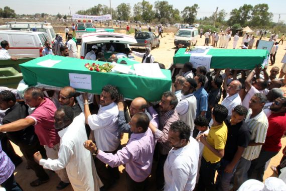 Libyans carry flag-draped coffins containing bodies of the relatives of former Libyan Interior Minister Khuwaylidi al-Hamidi