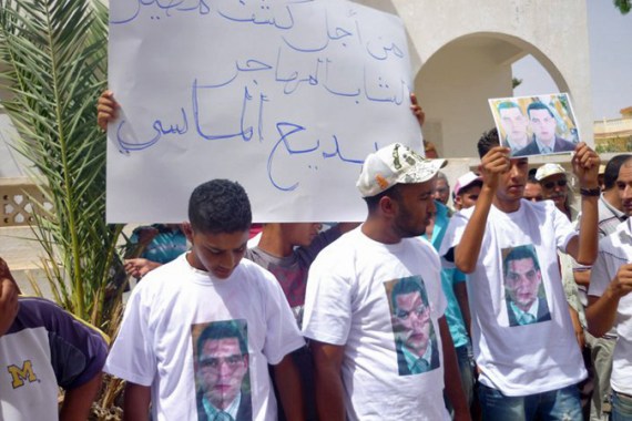 Protest sign in arabic tshirt face of El Massi Credit: Ridha Ezdini