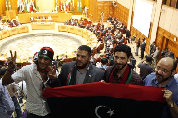 Libyans hold flag at Arab Leage meeting