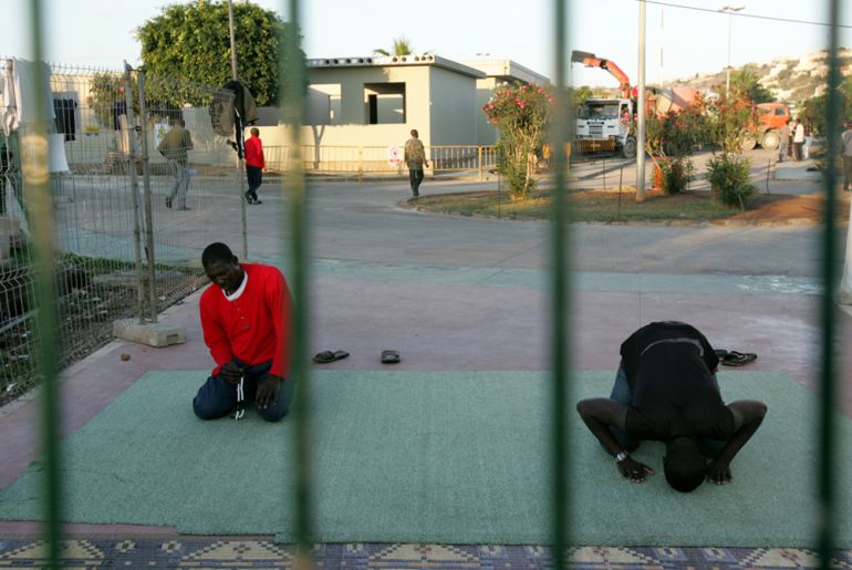 African migrants pray at the CETI, Short Stay Immigrant Center