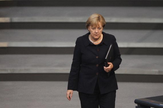 Merkel looking unhappy in front of steps