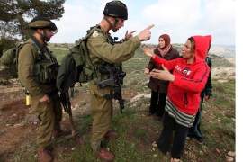 Israeli solider arguing with a protestor