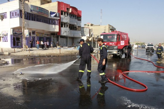 Iraqi firefighters at car bomb site