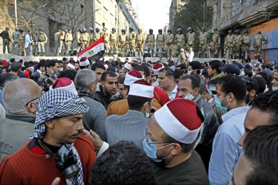 Protesters gather in front of an army barricade in Cairo