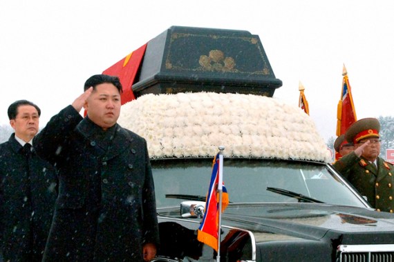 Kim Jong-un salutes next to Kim Jong-il''s funeral car