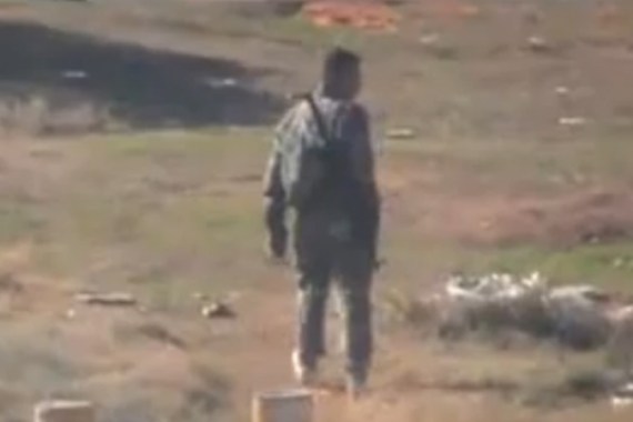 Syrian regime militiaman walking in Homs