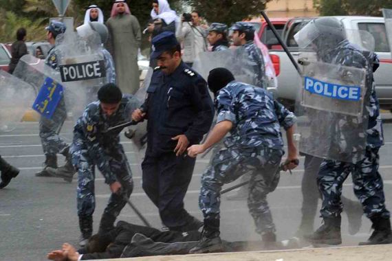 Kuwait police arresting demonstrator