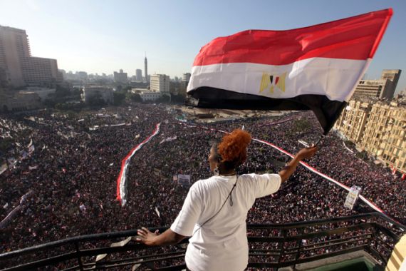 Woman waving flag at Tahrir