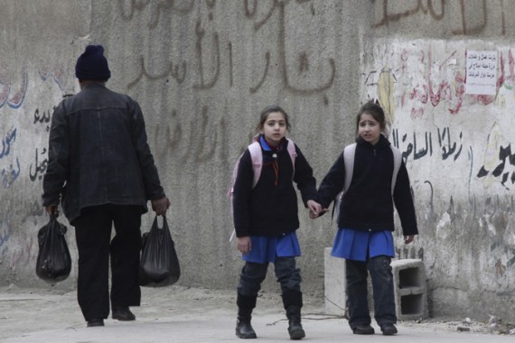 EDITOR''S NOTE: PICTURE TAKEN ON TOUR ORGANISED BY SYRIAN MINISTRY OF INFORMATION. Syrian children walk along a street in the Damascus suburb of Harasta February 15, 2012,. REUTERS/Stringer (SYRIA - Tags: SOCIETY)