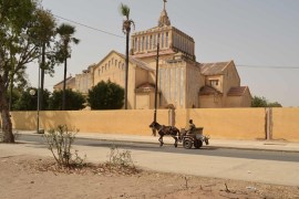 Man, donkey, church in Thies, Senegal - Azad Essa/AlJazeera