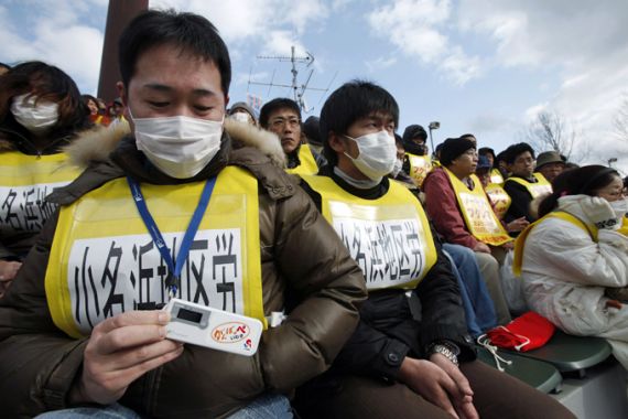 A protester shows his radiation dosimeter as he attends an anti-nuclear rally in Koriyama, Fukushima prefecture March 11, 2012, to mark the first anniversary of an earthquake and tsunami that killed thousands and set off a nuclear crisis. REUTERS/Yuriko Nakao (JAPAN - Tags: ANNIVERSARY DISASTER POLITICS ENERGY)