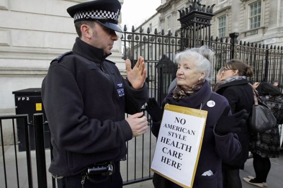 A police officer speaks to a demonstrator outside Downing Street in London February 20, 2012. Britain''s Health Secretary Andrew Lansley was heckled and jostled by demonstrators when arrived for a round table discussion on the future of the NHS, at Downing Street . REUTERS/Stefan Wermuth (BRITAIN - Tags: POLITICS HEALTH)