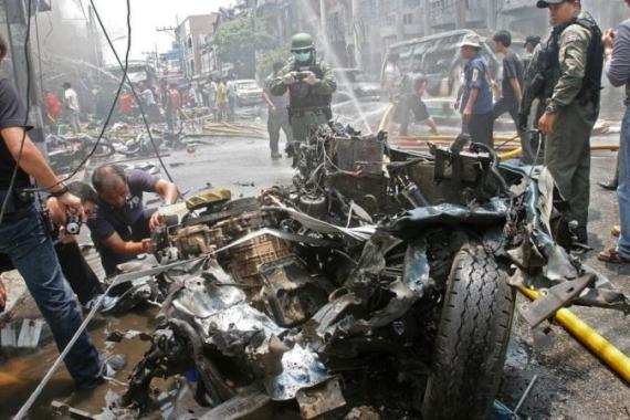 Thai bomb squad members inspect the wrec
