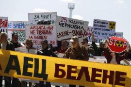 Demonstrators carry posters as they walk towards entrance of the construction site of Bulgaria''s second nuclear power plant near Belene