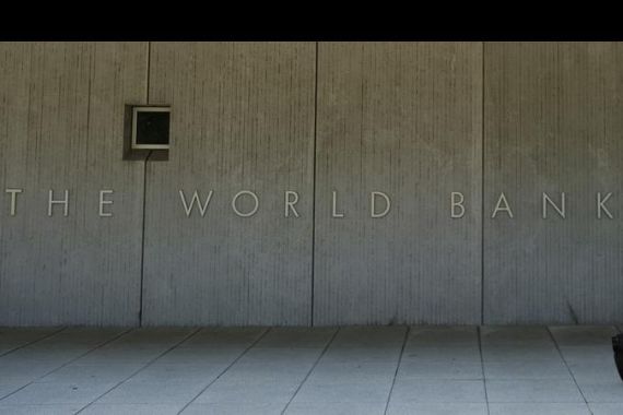 Pedestrians walk by the World Bank Group