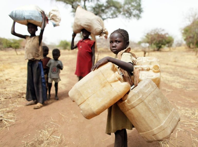 Children carry their family''s belonging as they go to Yida refugee camp in South Sudan outside Tess village in the rebel-held territory of the Nuba Mountains in South Kordofan