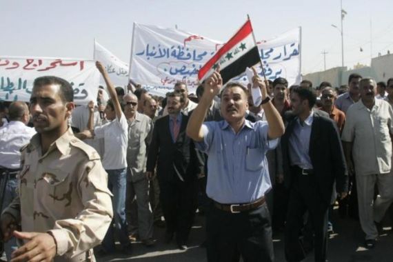 Residents chant slogans during a protest about the auctioning of Akkas gas field in Ramadi