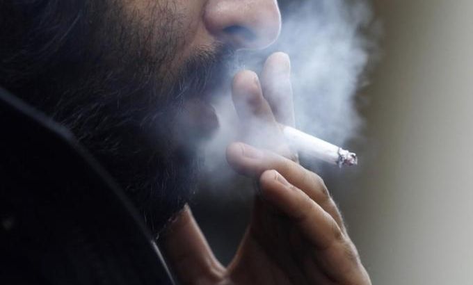 A man smokes a cigarette in central London