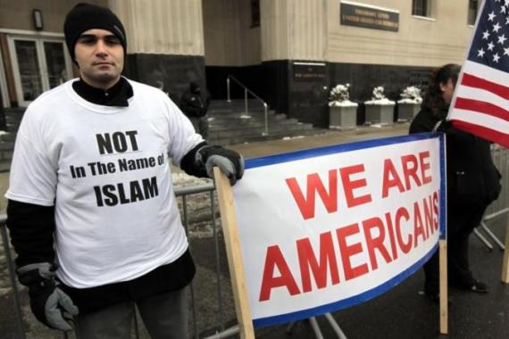Arab-American Ali Sayed holds a sign in front of the Federal court building as he joins a demonstration against terrorism in Detroit, Michigan