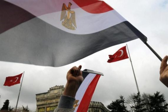 Demonstrators wave flags of Egypt during