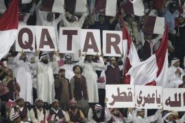 Qatari fans hold the banners to show the