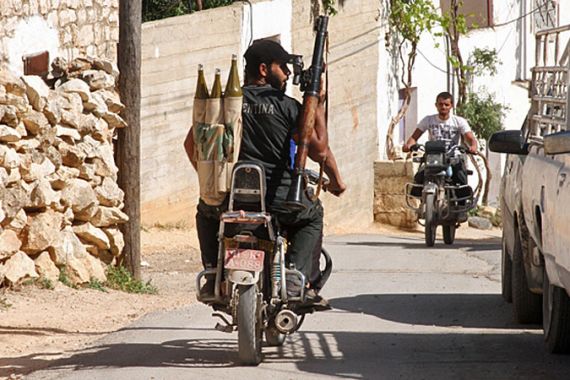 A member of the armed Syrian opposition group, the Sham Falcons, heads out on a mission in Idlib province [Tracey Shelton/Al Jazeera]