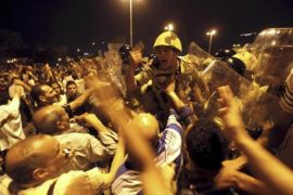 Egyptian demonstrators clash with military police standing guard at Tahrir Square in Cairo
