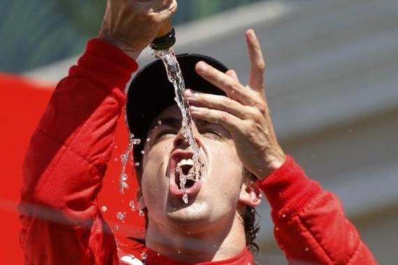 Ferrari Formula One driver Alonso drinks champagne during the podium ceremony after the European F1 Grand Prix at the Valencia street circuit