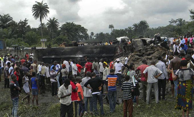 Nigerians survey the scene of a petrol tanker - explosion