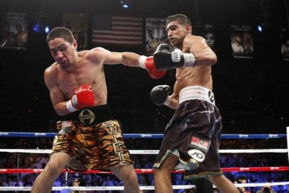 WBC champion Garcia of the U.S. connects with a punch on Khan of Britain that sends Khan to the canvas in Las Vegas