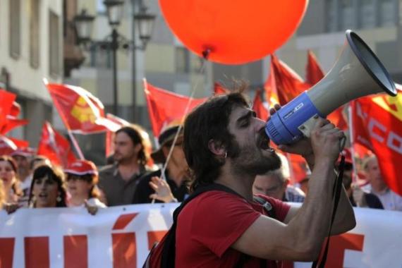 A man shouts slongans as workers protest over austerity measures in Oviedo
