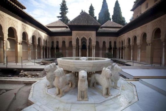 Water flows from the Lion Fountain in the Court of Lions at Alhambra Palace in Granada