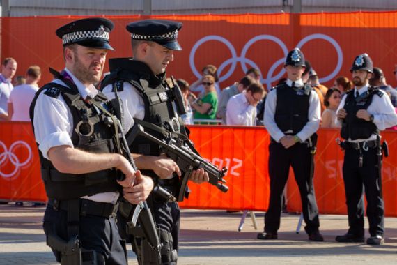 British police officers patrol in front of the Olympic stadium in London