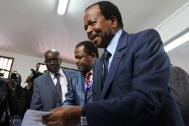 Cameroon''s President Paul Biya holds a ballot paper before casting his vote at a polling centre in Yaounde