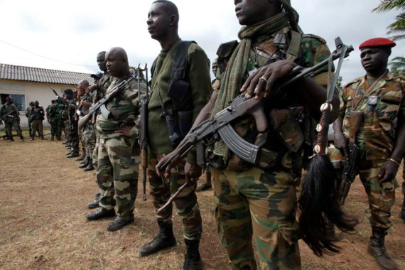 Members of the Ivory Coast Republican forces are seen ahead of their patrol in Dabou