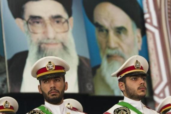 Soldiers stand guard under the pictures of Ayatollah Khomeini, the founder of the Islamic Republic, and Iran''s Supreme Leader Ayatollah Khamenei in Tehran