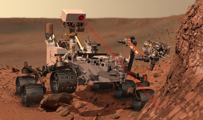 Artist''s concept depicts rover Curiosity, of NASA''s Mars Science Laboratory mission, as it uses its Chemistry and Camera instrument