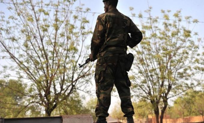 A Malian soldier takes position as junta