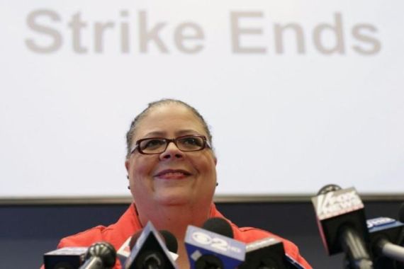 Chicago Teachers Union President Lewis smiles during a news conference in Chicago