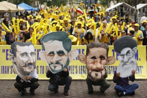 People wearing masks of Syrian President Bashar al-Assad, Iran''s President Mahmoud Ahmadinejad and Iran''s Supreme Leader Ayatollah Ali Khamenei protest in New York
