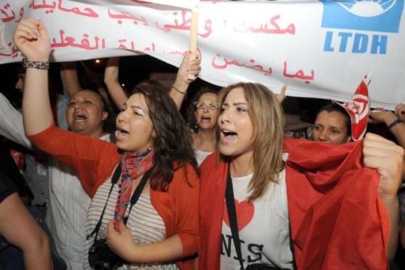 Tunisian women shout slogans during a pr