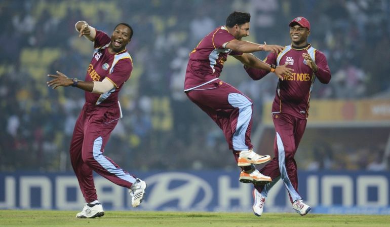 West Indies'' Rampaul celebrates with Pollard and Samuels after dismissing England''s Wright during the Twenty20 World Cup Super 8 cricket match at Pallekele, Sri Lanka